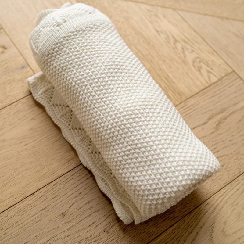 soft white knitted baby blanket by mabel fox cozy nursery essential